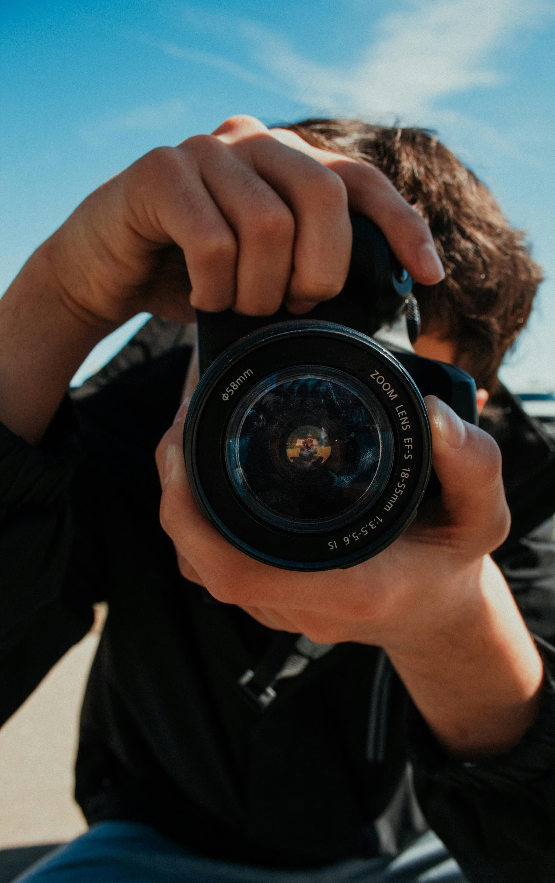 Photographer holding a camera during a city portrait session